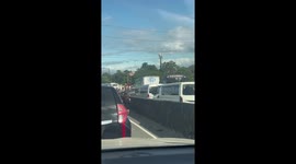 Impatient lady in Philippines walks through heavy traffic