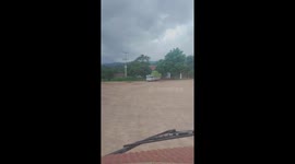 A small truck driver carrying hundreds of bunches of bananas filled the trunk and moved professionally on the road