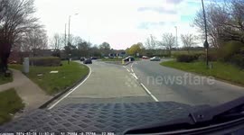 Cyclist falls at roundabout with her feet stuck in her cleats
