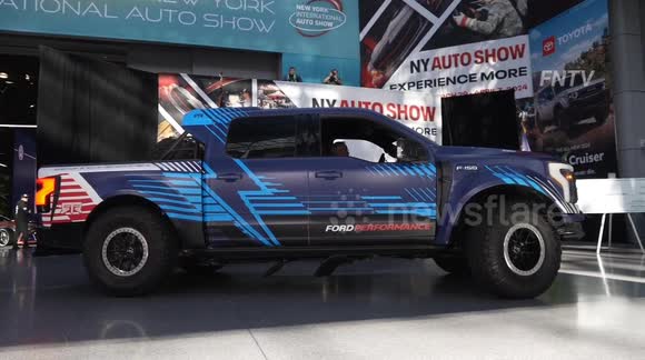 Climate Activists Dragged Out of New York Auto Show After Tossing Oil on EV