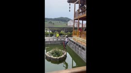 Chinese cyclist miraculously wheeling through pond stuns people