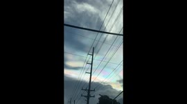 Colourful cloud iridescence form above a city in the Philippines