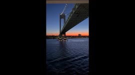 Passing under the Verrazzano-Narrows Bridge in New York Harbor at Sunrise