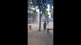 School children run for cover as dust devil tornado tears through field