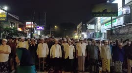 Muslims perform the night prayers on the 21st night of the holy fasting month of Ramadan on a street in Bogor