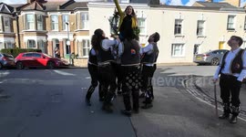 The Blackheath Morris Men perform the age-old ritual of chair lifting outside pubs in Greenwich