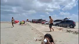 Man Falls Trying to Pass Soccer Ball at the Beach