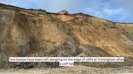 Homes dangling on a cliff edge after coastal erosion