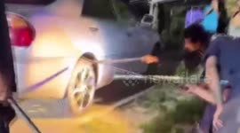 Huge king cobra rescued after getting stuck in car wheel while looking for shade