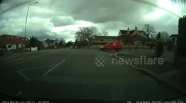 A van driver overtakes several cars causing people to flash and hold back as he drives heading towards them then turns right across the path of another oncoming car