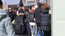 Walking past towards the London Eye in Central London on the Thames, London, United Kingdom