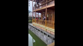 Extreme cyclist hops over pond in China