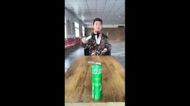 Chinese man throws cards to cut through flower stem