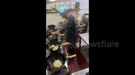 Chef cooks 10 portions of fried rice simultaneously in five pans