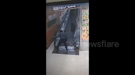 Terrifying moment woman falls into missing panel on supermarket’s escalator in China