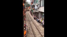 Tourists gather to witness train passing through Ha Noi's unique train street