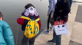 Chinese Children Take Their Turtles for a Stroll in the River