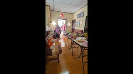 Pet Chihuahua holds incense stick while praying with family
