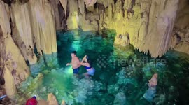 Couple has refreshing swim in cave pool