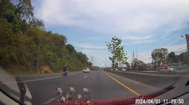 Kind motorcycle rider stops to clear up messy road
