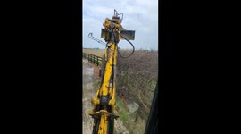 Using a Crane to Cut Hedges