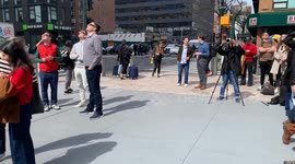 New Yorkers and Tourists  are seen watching the solar eclipse in Manhattan.