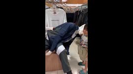 Desperate tears: child's struggle to upright a leaning mannequin