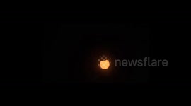 Solar eclipse seen above homes in Arkansas
