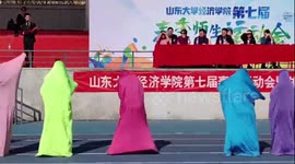 Students in colourful costumes perform at university sports day