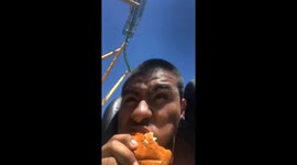 Daredevil challenges himself to eat CHEESEBURGER whilst on high-speed rollercoaster