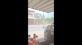 Storm blows plastic drum down street in Thailand