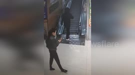 Hero risks life on collapsing escalator to save woman swallowed inside