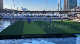 Players plunge into water during aqua rugby festival played on FLOATING pitch