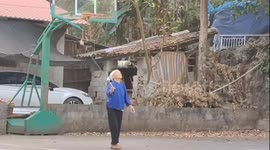 Elderly Chinese woman masters traditional embroidered ball toss