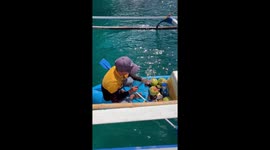 Vendor sells coconut rum from boat