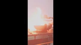 The chef expertly demonstrates his cooking skills over a nearly one-meter-high flame