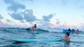Woman falls off board as she rides wave in surfing wipeout fail