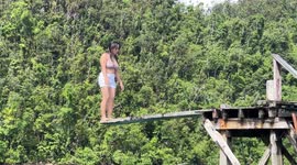 Girl has painful tumble from backflip diving into lake