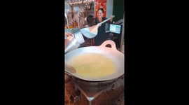 The woman makes a giant Vietnamese pancake 1 meter in diameter that costs 50 USD