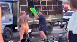 Two middle-aged tourist fight each other during Thai songkran festival