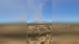 Dust devil tornado swirls along Route 66 in Arizona