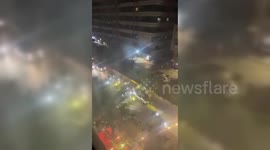 Hezbollah supporters march in the streets of Beirut suburbs celebrating Iran's attack on Israel