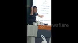 Hilarious moment when Chinese university lecturer's quiz backfires as projector reveals answer on his hand
