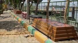 Six bums under! Old coffins turned into wooden benches at temple in Thailand