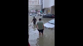 Residents navigate through submerged streets in UAE's Sharjah