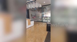 Water gushes from store's ceiling after it partially collapsed due to heavy rain