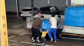 One Year Old Child Contributes to Help Adults Load Package onto Truck in China