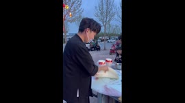 Food seller amazes locals with dough-throwing skills
