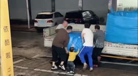 Sweet toddler lends a helping hand while loading truck
