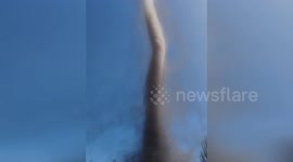 Dust devil tornado tears through car park in China